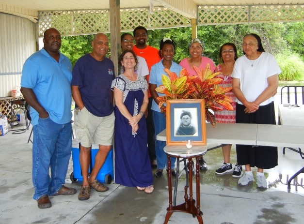 Aug. 2014 - Thibodeaux family gathering. Siblings Donald in navy shirt 2nd from left of photo, Sister Sylvia at far right, and Josie in the coral shirt hiding behind the plant, and a portrait of ancestor Elizabeth, the former slave woman who married white planter Onezime E Thibodeaux 